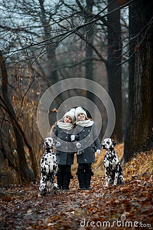 Twins girls portrait Dalmatian dogs Stock Photo