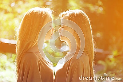 Twins. A group of young beautiful girls. Two women face close-up. Trendy stylish sisters Stock Photo