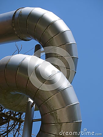 Twisted aluminium construction pipes against blue sky Stock Photo