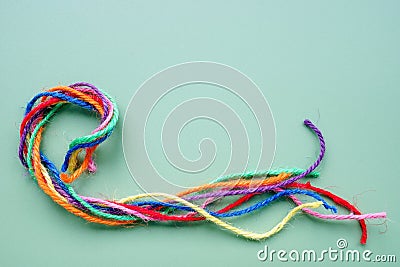 Twisted multicolored threads forming a rope. Unity and teamwork. Stock Photo