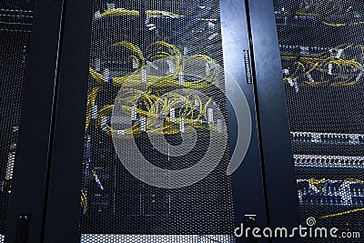 Twisting internet wires and optical cables in server room office racks. Modern data center working, connected and transmitting Stock Photo
