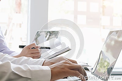 Two accounting Concepts, Male use notebook, pen and computer laptop to working financial and budget, inspector accountant concept Stock Photo