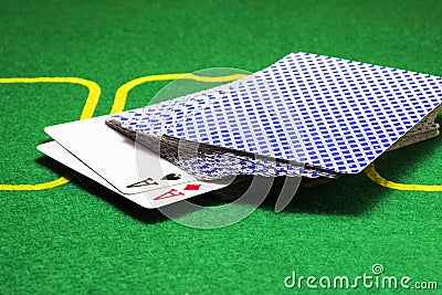 Two aces peeking out of a deck of cards Stock Photo