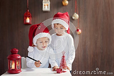 Two adorable boys, writing letter to Santa Stock Photo