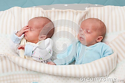 Adorable twin babies sleeping in the bed. Closeup portrait, caucasian child Stock Photo