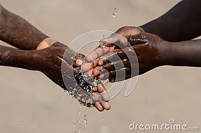 Two African Children Washing Hands Sanitizing Fingers to Avoid Contamination of Virus, Bacteria or Illness Stock Photo