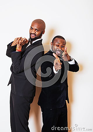 Two afro-american businessmen in black suits emotional posing, g Stock Photo