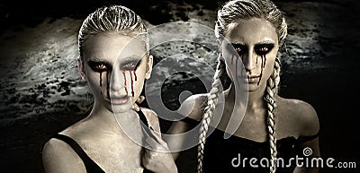 Horror portrait with two albino girls with bloody tears Stock Photo