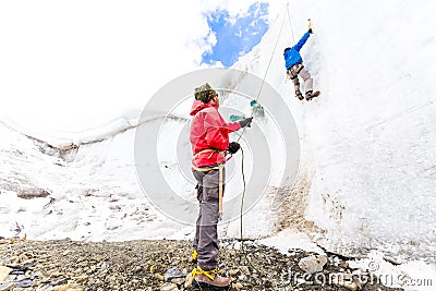 Two alpinists friends climbing ice glacier wall mountain Andes Peru Stock Photo