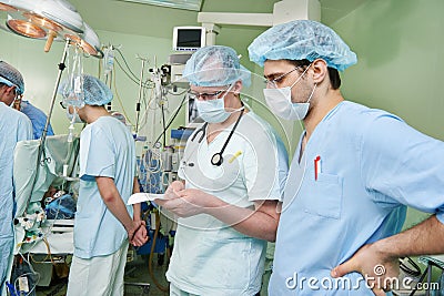 Two anaesthesiologist doctors at cardiac operation Stock Photo