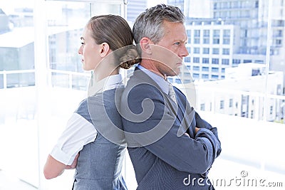 Two angry business colleagues standing back to back Stock Photo