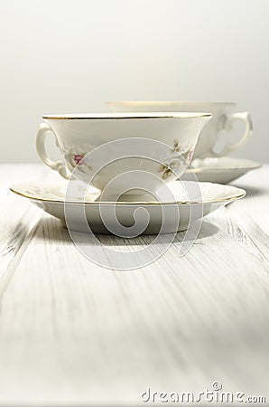 two antique teacups on white background Stock Photo