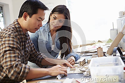 Two Architects Making Models In Office Together Stock Photo