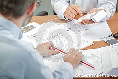 Two architects running numbers Stock Photo