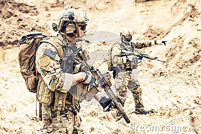 Special operations forces team raiding in desert Stock Photo