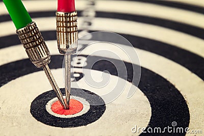 Two arrow dart hit the center of the target dartboard Stock Photo