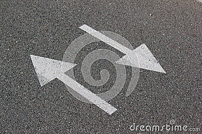 Two arrows on asphalt. Sign of two-way street Stock Photo
