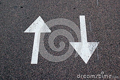 Two arrows on asphalt. Sign of two-way street. Stock Photo