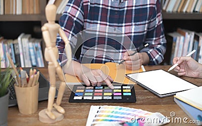 Two artists working on tablet, colour paper tone on workspace at the office Stock Photo