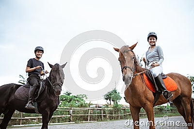 two asian equestrian athletes riding their respective horses Stock Photo