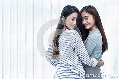 Two Asian Lesbian women looking together in bedroom. Couple people and Beauty concept. Happy lifestyles and home sweet home theme Stock Photo