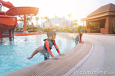 Asian siblings in playing together in Water Aqua park pool Stock Photo