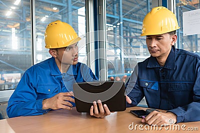 Two Asian workers analyzing information indoors Stock Photo