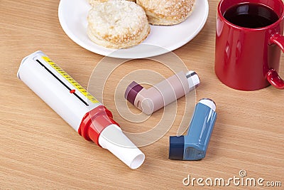 Two asthma inhalers and a peek flow meter on table Stock Photo