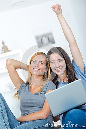 Two astonished roommates watching media content on line Stock Photo