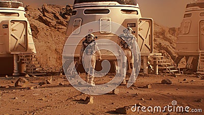 Two astronauts in spacesuits walk toward base on Mars Stock Photo