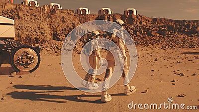 Two astronauts walk toward scientific base on Mars Stock Photo