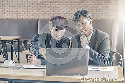 Two attractive businessmen having a meeting with laptop while having coffee Stock Photo