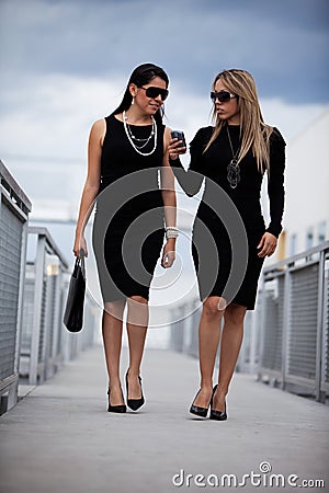 Two attractive hispanic businesswomen walking Stock Photo