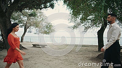 Two lovers meeting outdoors on romantic date. Happy couple standing at city park Stock Photo