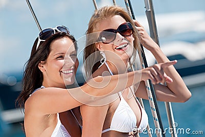 Two attractive smiling woman on sailboat Stock Photo