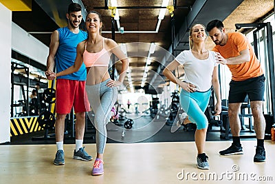 Two attractive women exercising with personal trainers Stock Photo