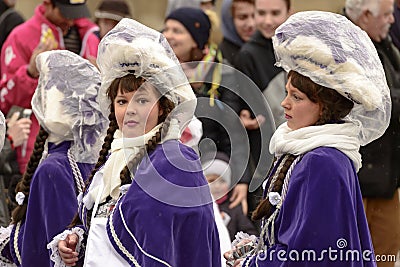 Two baby majorettes wrapped up against rain at Carnival parade, Editorial Stock Photo