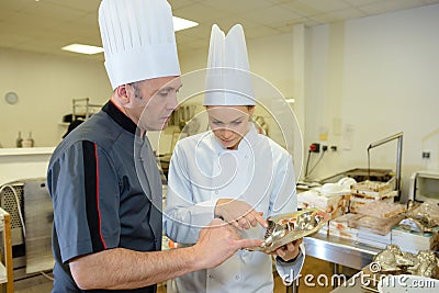 Two bakers talking in kitchen Stock Photo