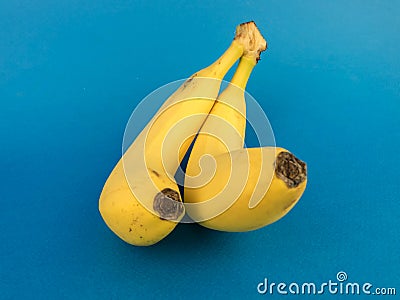 two bananas on a blue background Stock Photo
