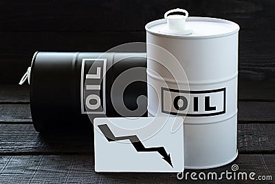 Two barrels of oil and the graph with a falling curve Stock Photo