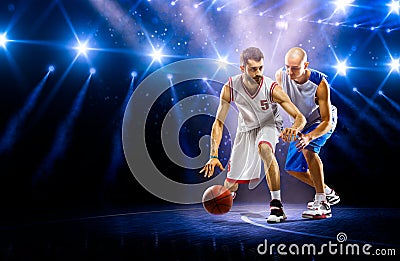 Two basketball players in spotlights Stock Photo