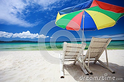 Two beach chairs and colorful umbrella Stock Photo