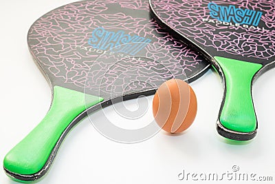 Two beach tennis rackets and an egg that replaces the ball. Editorial Stock Photo