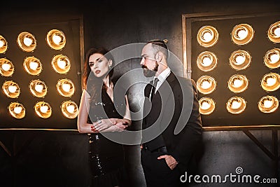 Two beautiful friends wearing elegance, standing near stage Stock Photo