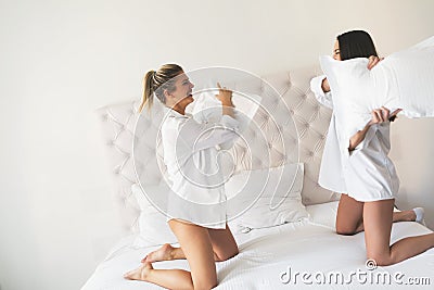 Two beautiful girls having fun on bed Stock Photo