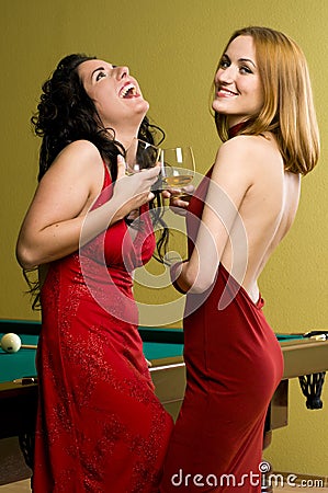 Two beautiful girls in red with cognac Stock Photo