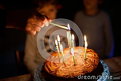 Two beautiful kids, little preschool boys celebrating birthday and blowing candles Stock Photo