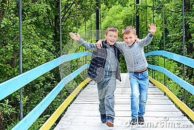 Two beautiful little guys running along the bridge in the Carpathians Editorial Stock Photo