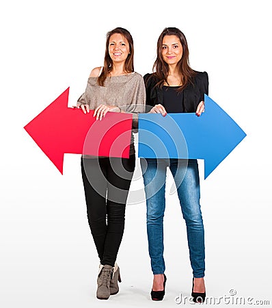 Two beautiful women holding red and blue arrow, left and right Stock Photo