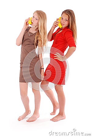 Two beautiful young caucasian girl with banana phone Stock Photo
